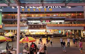 People consuming leftovers at a Chinatown hawker center

