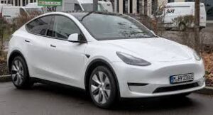 "Tesla Model Y electric SUV parked on a city street"