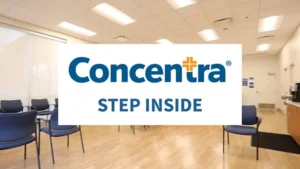 Patient checking in at a Concentra Urgent Care reception desk
